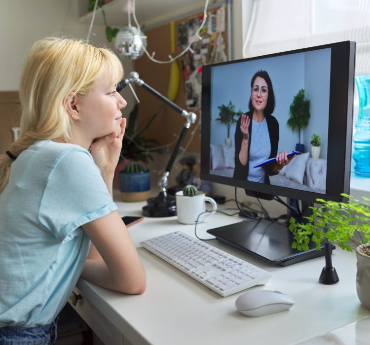 Online session of teenage girl and psychologist, social worker. Young female talking to therapist, teacher, at home looking at computer screen. Professional help, mental health, education, adolescence